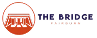 Circular orange emblem with a stylized bridge and the words “THE BRIDGE FAIRBANKS” in blue and orange